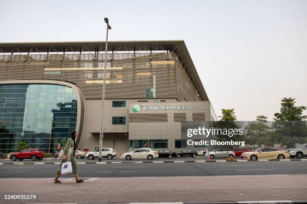 Pedestrian passes an Emirates Central Cooling Systems Corporation district cooling plant in the Dubai International Financial Centre area of Dubai,...