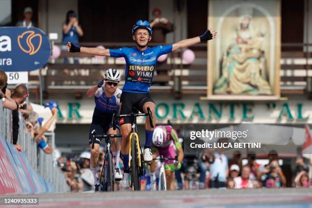 Team Jumbo's Dutch rider Koen Bouwman celebrates as he crosses the finish line to win the 19th stage of the Giro d'Italia 2022 cycling race, 178...