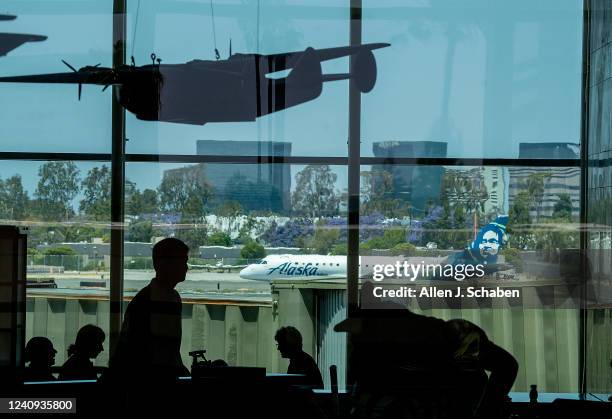 Santa Ana, CA An airplane prepares to take off as passengers make their way to their gates during the Memorial Day weekend getaway at John Wayne...