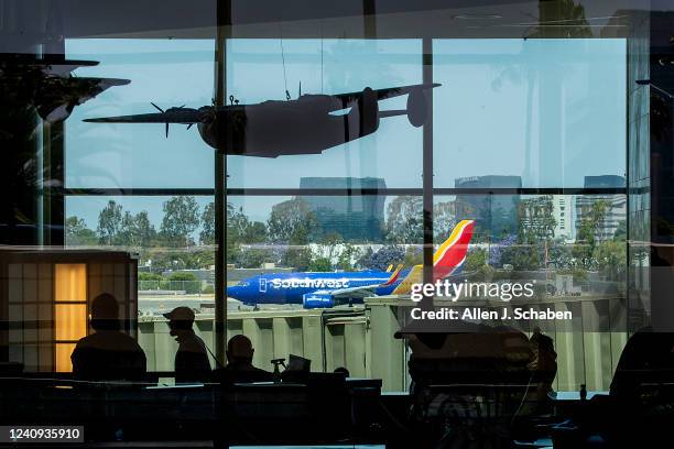Santa Ana, CA An airplane prepares to take off as passengers make their way to their gates during the Memorial Day weekend getaway at John Wayne...