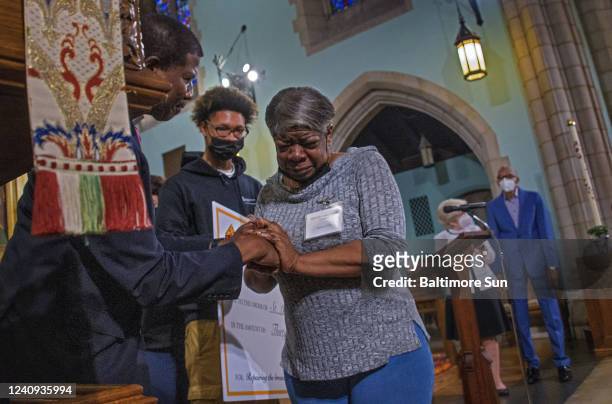 The Right Rev. Eugene Taylor Sutton, Episcopal bishop of Maryland, left, congratulates Darlene Clark as she sheds tears of joy as she, Jermaine...