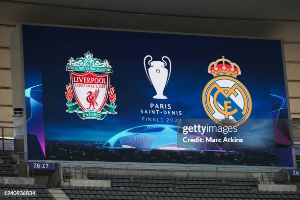 The club crests of Liverpool and Real Madrid are seen on the giant screen during the Liverpool FC Training Session at Stade de France on May 27, 2022...