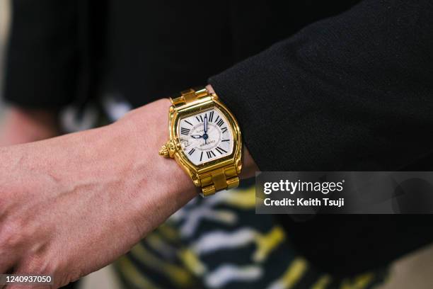 Visitor is seen wearing Asos jacket, Cartier watch, Cavalli pants during Art Basel Hong Kong 2022 on May 27, 2022 in Hong Kong, China.