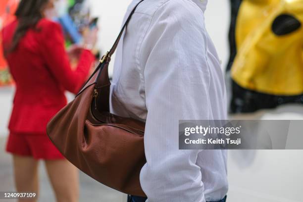 Visitor is seen wearing Zara shirt, Celine handbag during Art Basel Hong Kong 2022 on May 27, 2022 in Hong Kong, China.