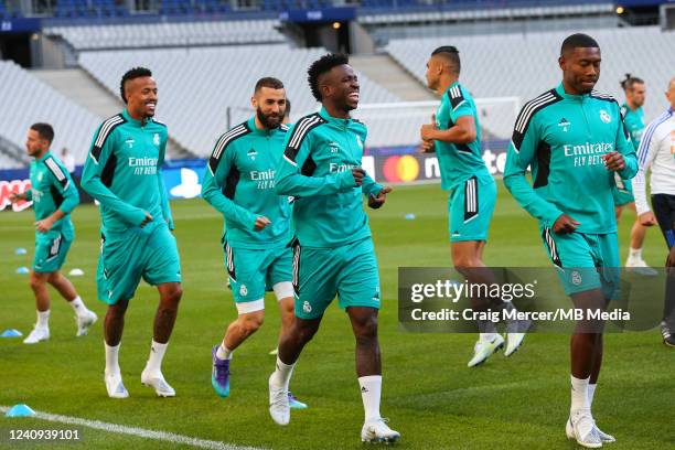 Vinicius Junior, Karim Benzema and Eder Militao of Real Madrid joke during training at Stade de France on May 27, 2022 in Paris, France. Real Madrid...