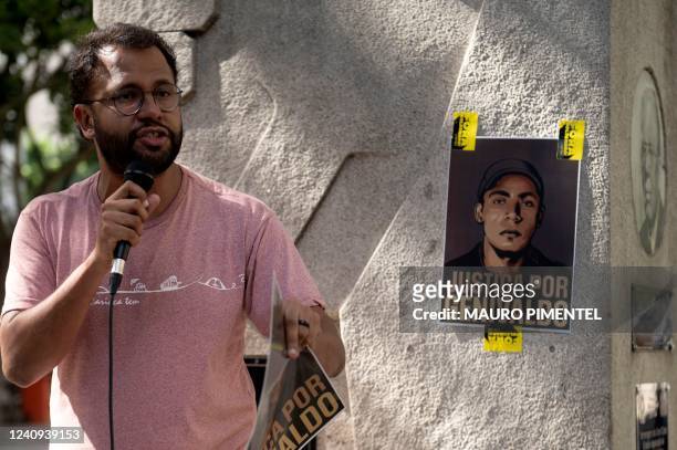 Pastor and activist Henrique Vieira speaks next to a sign reading Justice for Genivaldo during an event in honor of Genivaldo de Jesus Santos at the...