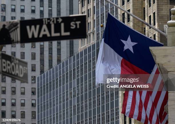 Texas State flag and the US flag are seen at the New York Stock Exchange in New York on May 27, 2022.