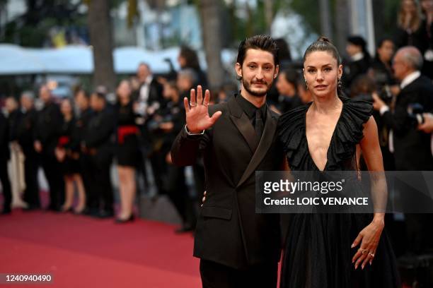 French actor Pierre Niney and his wife Australian actress Natasha Andrews arrive for the screening of the film "Mascarade" during the 75th edition of...