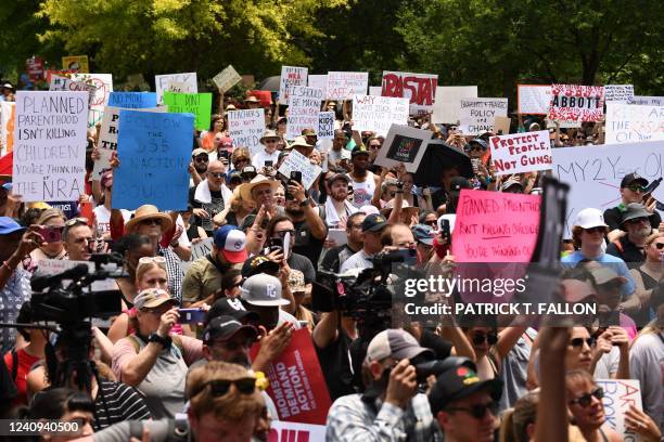 Protesters in support of gun control hold signs accross from the National Rifle Association Annual Meeting at the George R. Brown Convention Center,...