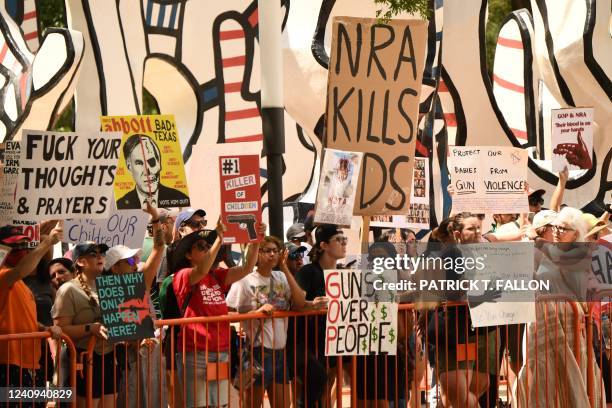 Protesters in support of gun control hold signs accross the National Rifle Association Annual Meeting at the George R. Brown Convention Center, on...