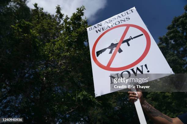 Gun control advocate holds a sign during a protest across from the National Rifle Association Annual Meeting at the George R. Brown Convention...