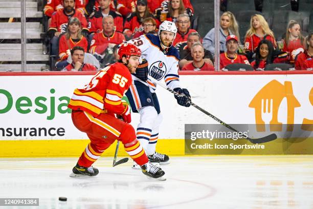 Edmonton Oilers Center Leon Draisaitl passes the puck past Calgary Flames Defenceman Noah Hanifin during the third period of game 5 of the second...