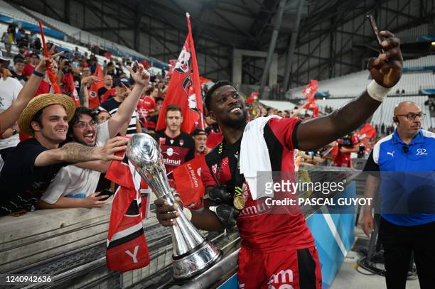 Lyon's French flanker Patrick Sobela takes selfies as he celebrates with supporters after winning the European Challenge Cup rugby union final match...