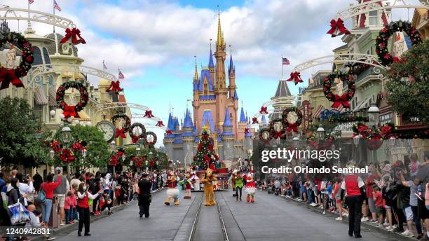 Crowds line Main Street USA, with Cinderella&apos;s Castle on the horizon, at the Magic Kingdom at Walt Disney World, in Lake Buena Vista, Florida,...