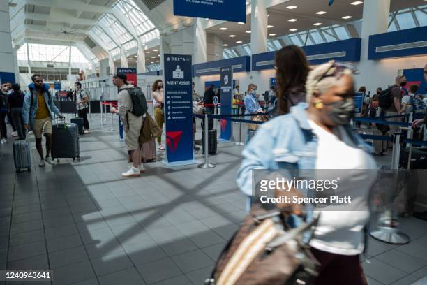 People travel through the terminal at John F. Kennedy Airport at the start of the Memorial Day weekend on May 27, 2022 in New York City. The holiday...