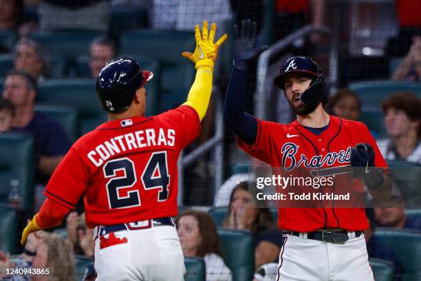 William Contreras reacts with Dansby Swanson of the Atlanta Braves after scoring during the fifth inning against the Miami Marlins at Truist Park on...