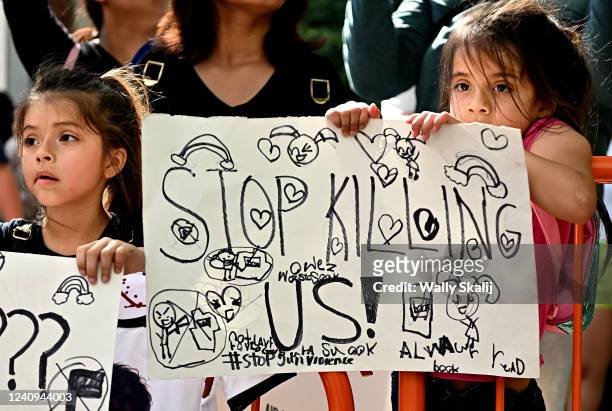 Houston, Texas May 27, 2022- A young girl holds a sign during a protest outside the George R. Brown Convention Center in Houston Friday as the NRA...