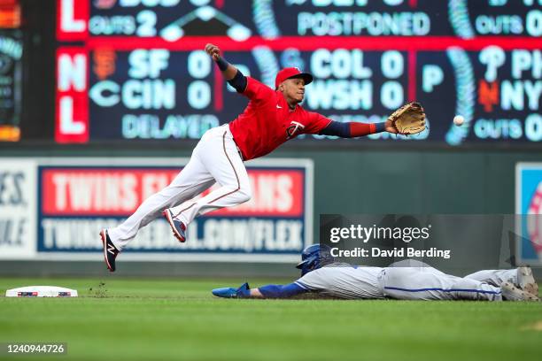 Bobby Witt Jr. #7 of the Kansas City Royals steals second base against Jorge Polanco of the Minnesota Twins in the first inning of the game at Target...