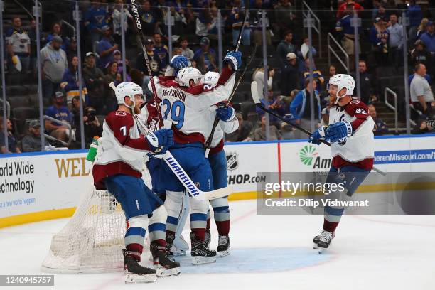 Devon Toews, Nathan MacKinnon and Gabriel Landeskog of the Colorado Avalanche join their teammates to celebrate after winning Game Six to clinch the...