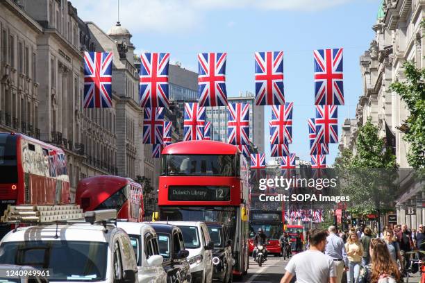 Traffic on Regent Street with Union Jack flags in the background to mark The Queen's 70-year reign. In June, Her Majesty The Queen will be...