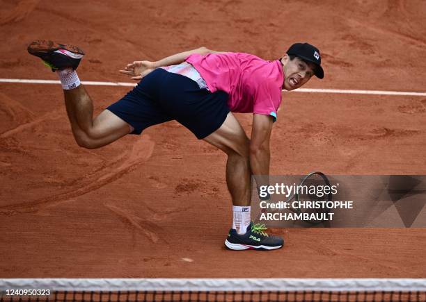 Mackenzie Mcdonald returns to Italy's Jannik Sinner during their men's singles match on day seven of the Roland-Garros Open tennis tournament at the...