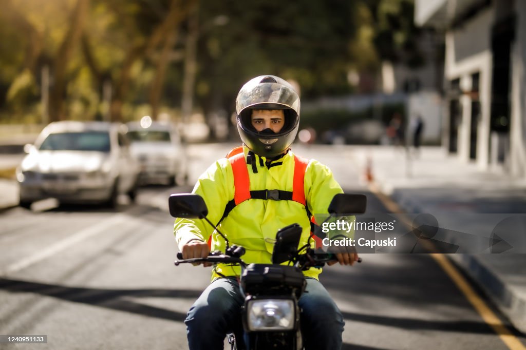 Delivery man riding a motorcycle - motoboy