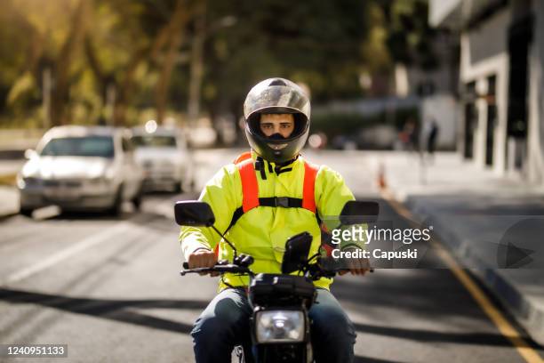 delivery man riding a motorcycle - motoboy - motoboy stock pictures, royalty-free photos & images