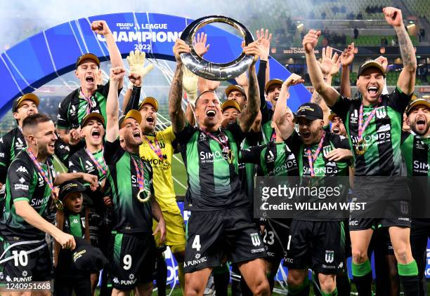 Western United's players celebrate with the trophy after winning the A-League football grand final against Melbourne City in Melbourne on May 28,...