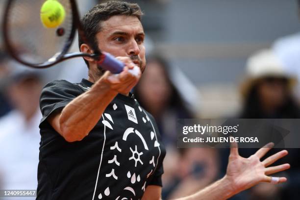 France's Gilles Simon returns the ball to Croatia's Marin Cilic during their men's singles match on day seven of the Roland-Garros Open tennis...