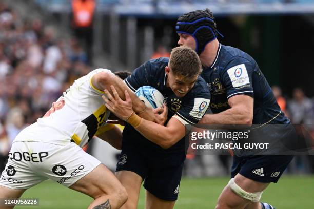 Leinster's Irish centre Garry Ringrose is tackled by La Rochelle's French wing Jeremy Sinzelle during the European Rugby Champions Cup, rugby union...