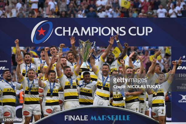 La Rochelle's players celebrate with the trophy after winning the European Rugby Champions Cup, rugby union final between Stade Rochelais and...