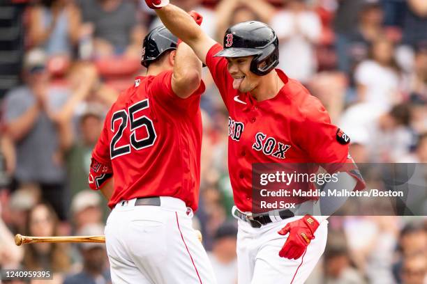 Bobby Dalbec of the Boston Red Sox reacts with Kevin Plawecki of the Boston Red Sox after hitting a home run during the sixth inning of game one of a...