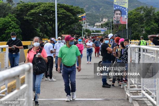 People cross the Simon Bolivar International Bridge from San Antonio del Tachira, Venezuela, to Cucuta in Colombia, on May 28 on the eve of the...