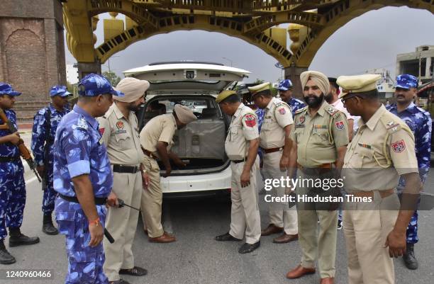 Rapid Action Force personnel and Punjab Police personnel screen a vehicle at Golden Gate ahead of anniversary of Operation Blue Star, on May 28, 2022...