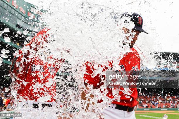 Starting pitcher Nathan Eovaldi of the Boston Red Sox gets water dumped on him after pitching a complete game in their 5-3 win over the Baltimore...