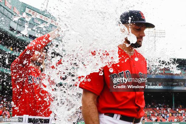 Starting pitcher Nathan Eovaldi of the Boston Red Sox gets water dumped on him after pitching a complete game in their 5-3 win over the Baltimore...