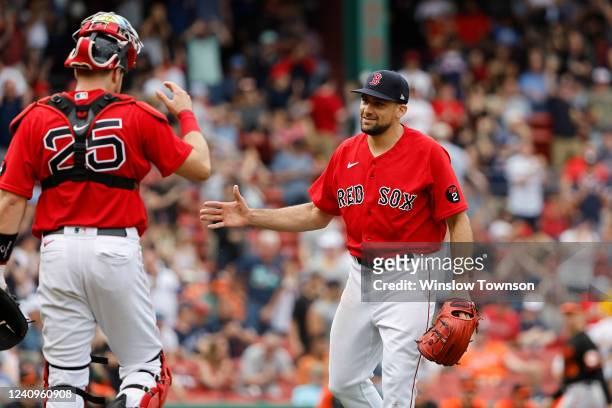 Catcher Kevin Plawecki of the Boston Red Sox moves in to congratulate pitcher Nathan Eovaldi of the Boston Red Sox after their 5-3 win over the...