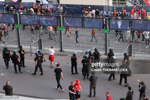 Police patrol at the fence as fans were prvented form getting inside prior to the UEFA Champions League final football match between Liverpool and...