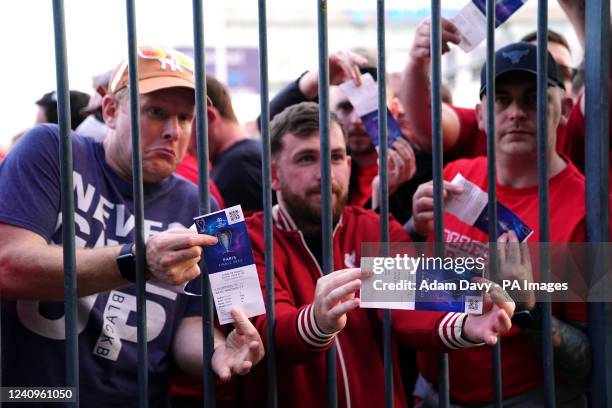 Liverpool fans stuck outside the ground show their match tickets during the UEFA Champions League Final at the Stade de France, Paris. Picture date:...