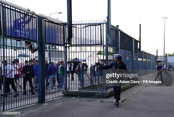 Police use pepper spray against fans outside the ground as the kick off is delayed during the UEFA Champions League Final at the Stade de France,...