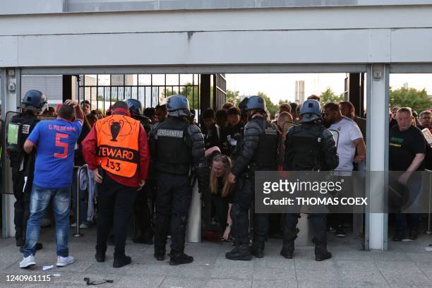 Police patrol at the gates as some fans were prevented form getting inside prior to the UEFA Champions League final football match between Liverpool...