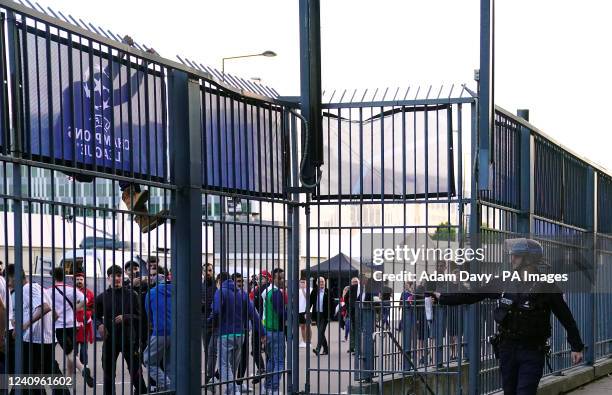 Police use pepper spray against fans outside the ground as the kick off is delayed during the UEFA Champions League Final at the Stade de France,...