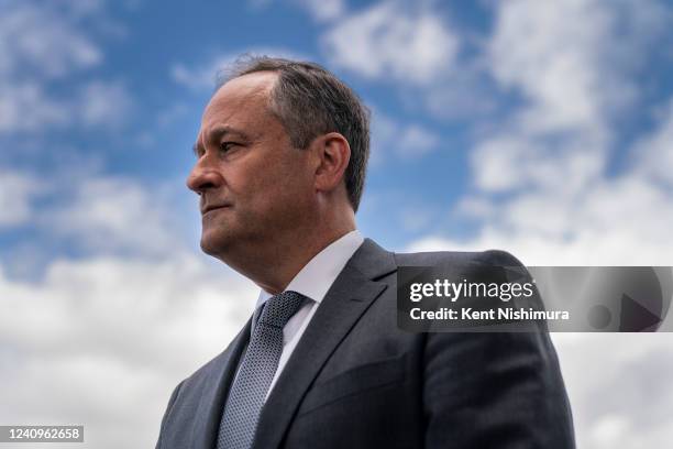 Second Gentleman Doug Emhoff looks on as Vice President Kamala Harris speaks to the press under the wing of Air Force 2 at Buffalo...