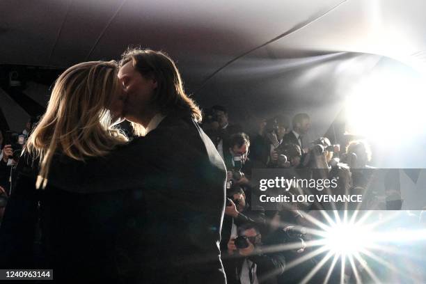 Belgian film director Felix Van Groeningen and Belgian director Charlotte Vandermeersch kiss during a photocall after they equally won the Jury Prize...