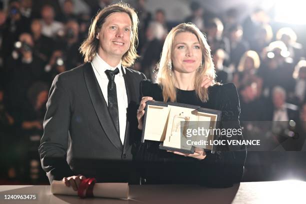 Belgian film director Felix Van Groeningen and Belgian director Charlotte Vandermeersch pose during a photocall after they equally won the Jury Prize...