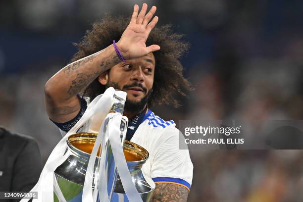 Real Madrid's Brazilian defender Marcelo celebrates with the Champions League trophy after Madrid 's victory in the UEFA Champions League final...