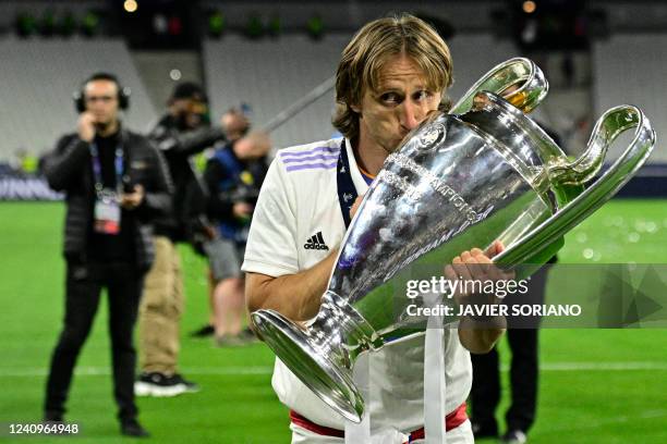 Real Madrid's Croatian midfielder Luka Modric kisses the trophy after the UEFA Champions League final football match between Liverpool and Real...