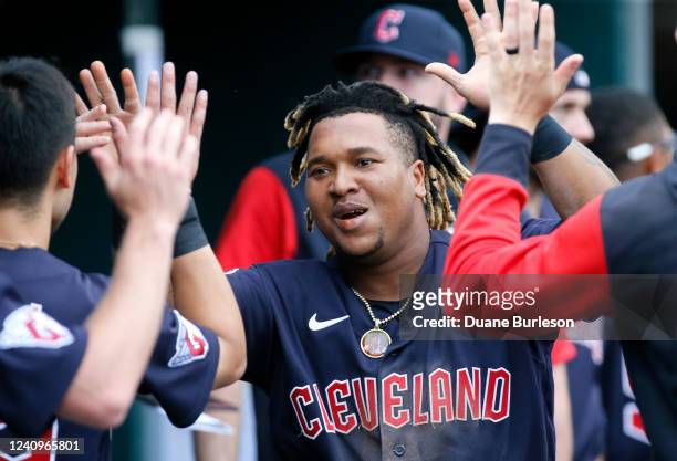 Jose Ramirez of the Cleveland Guardians celebrates with teammates after scoring against the Detroit Tigers on a single by Josh Naylor during the...