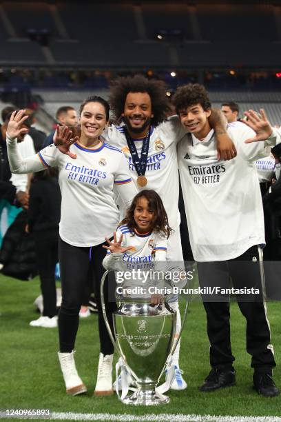 Marcelo of Real Madrid poses with his family and the trophy following his sides victory at the end of the UEFA Champions League final match between...