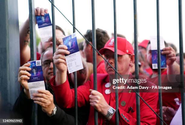 Liverpool fans stuck outside the ground show their match tickets during the UEFA Champions League Final at the Stade de France, Paris. Picture date:...